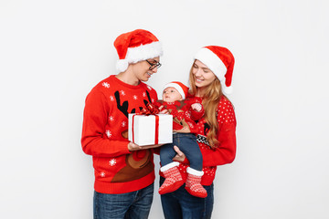 Happy family, dad mom and little baby, celebrate Christmas and give Christmas presents, on a white background