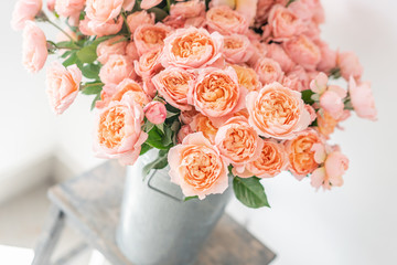 Roses of multicolor, pastel pink and pale orange color. Lots of buds. Floral natural backdrop. Flower shop concept