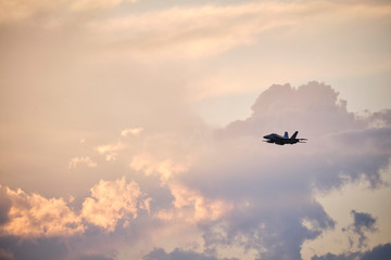 Australian Air Force fighter jet flying through Brisbane at sunset