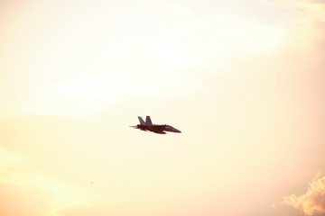 Australian Air Force fighter jet flying through Brisbane at sunset
