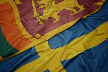 waving colorful flag of sweden and national flag of sri lanka.