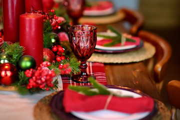 Christmas table set with wreath and red candles. Eve Xmas.