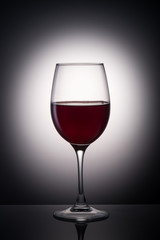 glass of wine on a gradient background