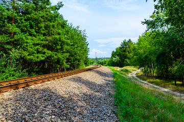 Fototapeta na wymiar Old railroad in forest on summer