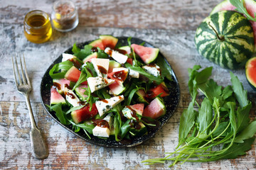 Healthy salad with watermelon, arugula and blue cheese. Arugula watermelon salad. Selective focus. Macro.