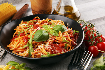 Plate of delicious spaghetti Bolognaise or Bolognese with savory minced beef and tomato sauce garnished with parmesan