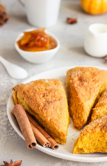 Traditional English cuisine. Breakfast with spicy pumpkin scones, a cup of tea and milk.