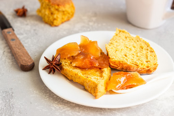 Traditional English cuisine. Breakfast with spicy pumpkin scones, a cup of tea and milk.