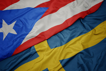 waving colorful flag of sweden and national flag of puerto rico.