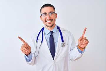 Young doctor man wearing stethoscope over isolated background smiling confident pointing with fingers to different directions. Copy space for advertisement