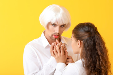 Portrait of young transgender couple on color background