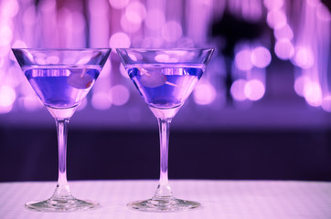 Colorful pair of martini drinks on bar 