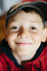 Portrait of cute laughing kid looking at camera. Top point of view