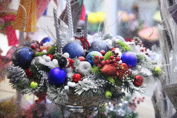 Basket with Christmas toys, snowman, balls, it's snowing