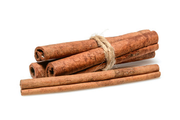 Cinnamon sticks for cooking and cosmetics. Four sticks close up macro isolated on white background with shadow. Full depth of field, high resolution.
