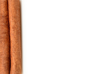 White background with cinnamon stick on left side. Close up macro isolated on white background with shadow. High resolution.