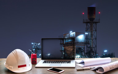 Double exposure Engineers holding safety helmet in arms and holding walk talky in hands with oil and gas refinery background on industry concept