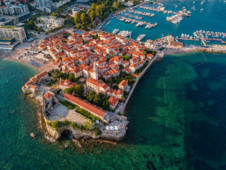 Aerial view of Budva, the old city (stari grad) of Budva, Montenegro. Jagged coast on the Adriatic Sea. Center of Montenegrin tourism, well-preserved medieval walled city, sandy beaches