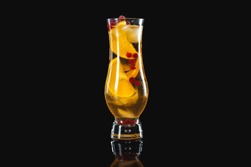 Glass of tasty cocktail on dark background