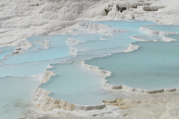 Pamukkale in Turkey is known for its mineral-rich thermal waters flowing down white travertine terraces. Pamukkale is nicknamed the cotton castle because of its white appearance.