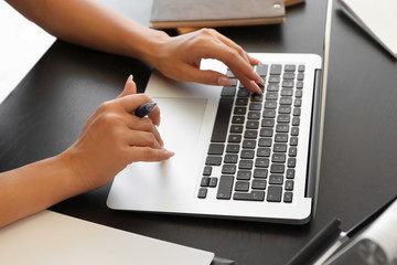 Young woman working on laptop at table