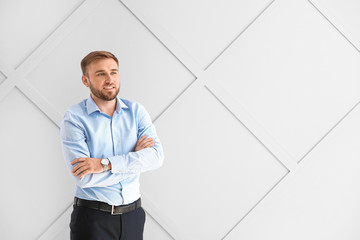 Portrait of handsome businessman on light background