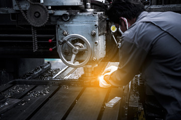 Professional workers are doing the milling process for metal parts, metal machinery in large industrial plants-image