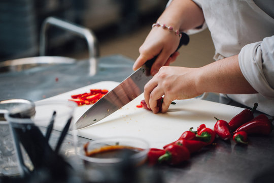 Chef Chopping Peppers In The Kitchen