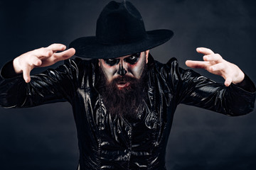 Celebrate Halloween in America. Scary face man with horror Make up holding Pumpkin head jack...