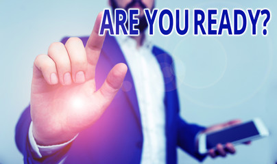 Conceptual hand writing showing Are You Ready Question. Concept meaning used telling someone start something when feel prepared Businessman pointing with pen in empty copy space