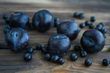 Plums on a wooden background