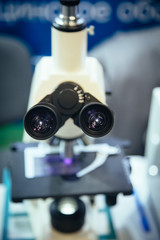 Ocular eyepiece lenses of binocular microscope, close up, selective focus