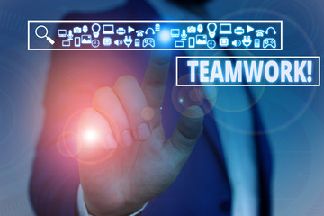 Text sign showing Teamwork. Business photo showcasing combined action of group especially when effective and efficient Male human wear formal work suit presenting presentation using smart device