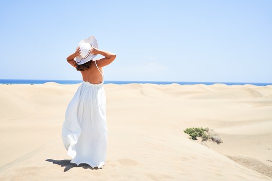 Young beautiful woman smiling happy enjoying summer vacation at maspalomas dunes beach