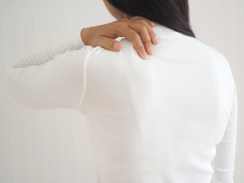 adhesive capsulitis in asian woman and she touching her shoulder symptom of pain and stiffness cause of swimming and use for health care concept.