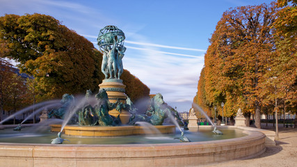 Paris, France - October 12, 2019: The Fontaine de l'Observatoire is a monumental fountain located in the Jardin Marco Polo, south of the Jardin du Luxembourg in the 6th arrondissement of Paris - obrazy, fototapety, plakaty