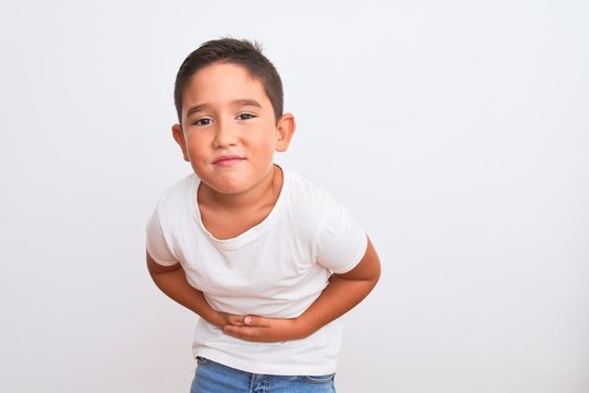 Beautiful Kid Boy Wearing Casual T-shirt Standing Over Isolated White Background With Hand On Stomach Because Nausea, Painful Disease Feeling Unwell. Ache Concept.