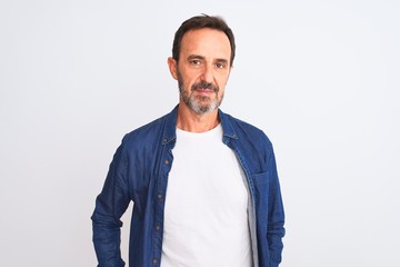Middle age handsome man wearing blue denim shirt standing over isolated white background Relaxed...