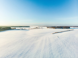 Beautiful aerial view of snow covered fields. Rime ice and hoar frost covering trees.