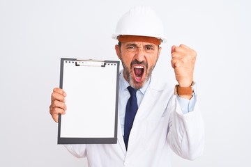 Senior engineer man wearing security helmet holding clipboard over isolated white background annoyed and frustrated shouting with anger, crazy and yelling with raised hand, anger concept