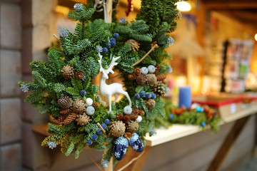 Beautiful fir tree wreath as a decoration of a wooden market stall on Christmas market in Riga, Latvia.