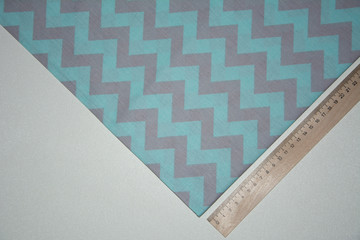 Fabric, green textile with a zigzag pattern on a white table.