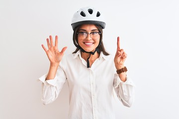 Beautiful businesswoman wearing glasses and bike helmet over isolated white background showing and pointing up with fingers number six while smiling confident and happy.