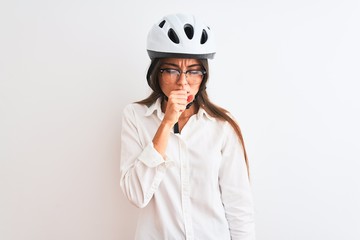 Beautiful businesswoman wearing glasses and bike helmet over isolated white background feeling unwell and coughing as symptom for cold or bronchitis. Healthcare concept.