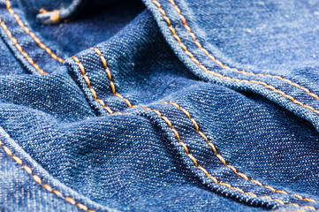 clothing items blue stonewashed faded jeans cotton fabric texture with seams, clasps, buttons and...