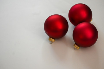 Red Christmas balls on white board space