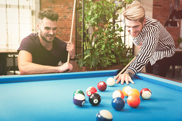 Employees playing in billiards at office - Powered by Adobe