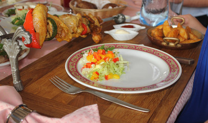  salad on a plate at the festive table. skewers on a skewer portioned.