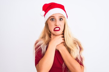 Young beautiful woman wearing Christmas Santa hat over isolated white background shouting and suffocate because painful strangle. Health problem. Asphyxiate and suicide concept.