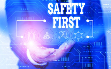 Handwriting text writing Safety First. Conceptual photo used to say that the most important thing is to be safe Male human wear formal work suit presenting presentation using smart device